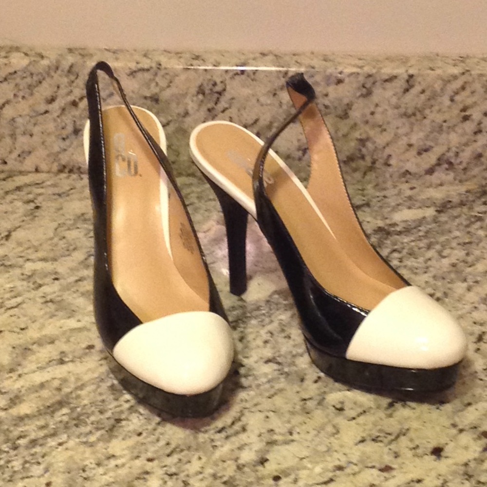 Black patent leather pumps w/ white cap toe detail